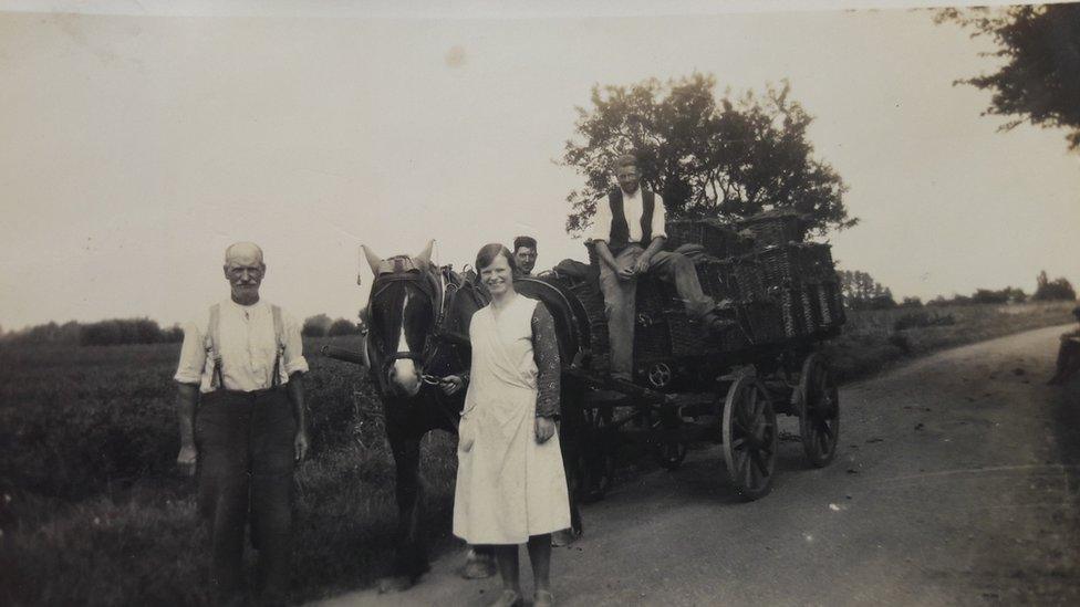 A man and woman with a horse and dray