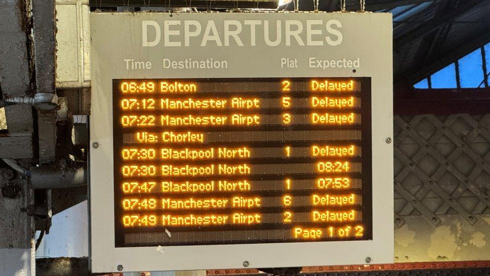 A departures board displaying delayed trains