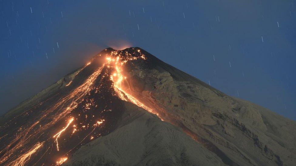 Fuego volcano spews ash, as seen from the city of Alotenango in Sacatepequez departament, 65 km southeast of Guatemala City, on February 1, 2018