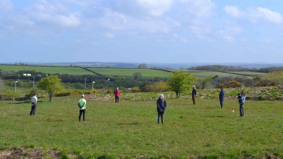 volunteers standing at ancient stone circle unearthed in Cornwall