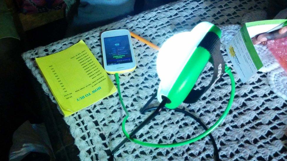 Solar lamp charging mobile phone