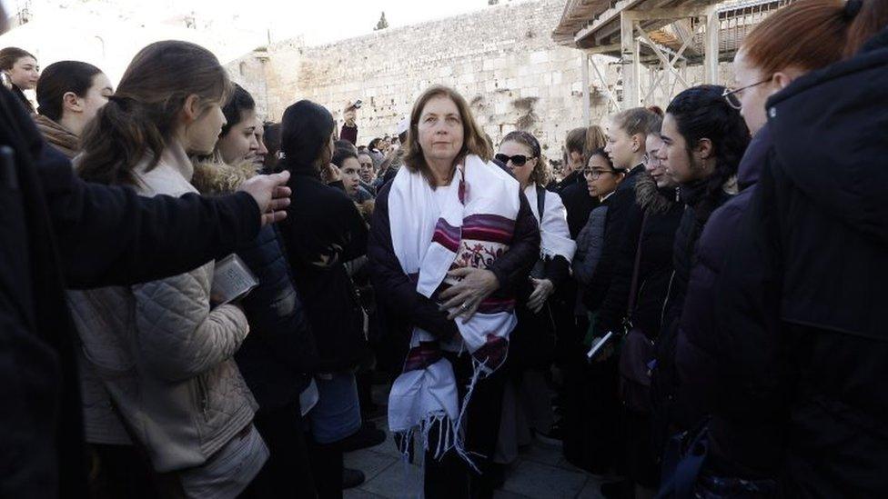 Anat Hoffman (C), the head of the liberal Jewish religious movement "Women of the Wall", leaves Judaism's holiest prayer site of the Western Wall in the Old City of Jerusalem on 8 March 2019