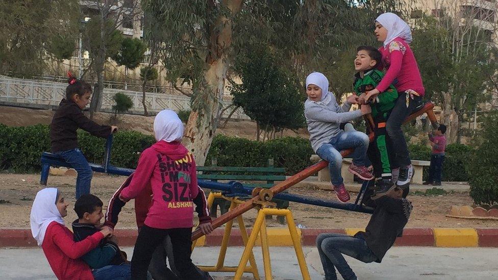 Syrian children play in a park in Damascus