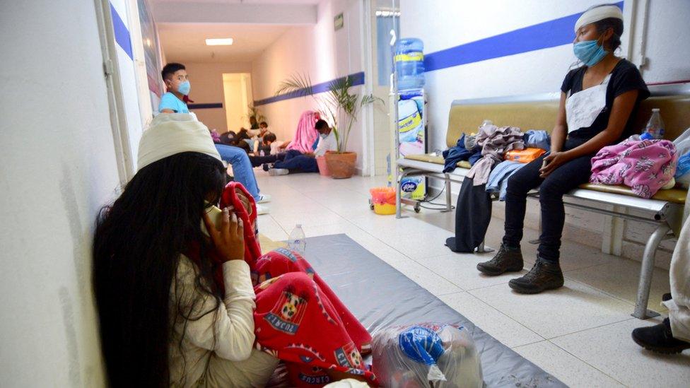 People injured in a truck accident that left more than 50 people dead, most of them migrants from Guatemala, sit at a clinic