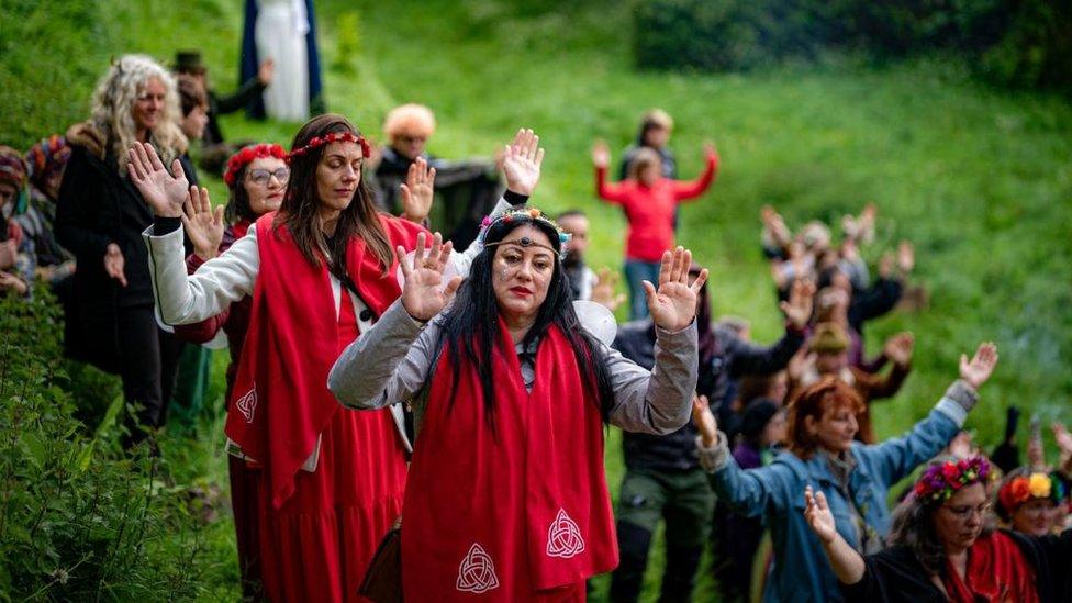 A group of people with their hands up