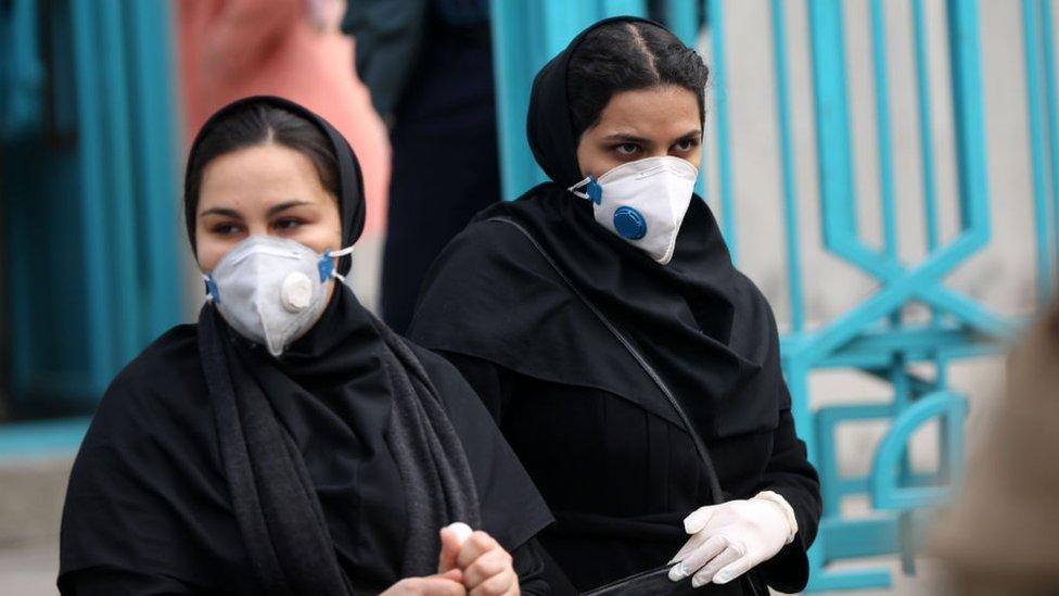 People wear face masks in Tehran