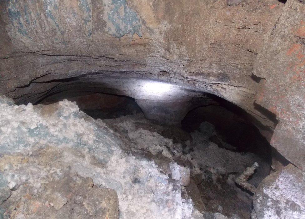 Rubble in a cave underneath a pub