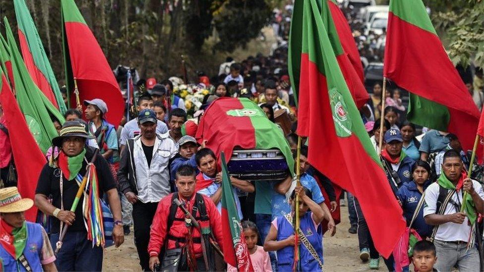 Colombian indigenous people carry the coffin of Kevin Mestizo, who was killed by unknown assailants in Toribio