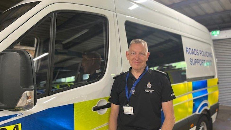 Police officer standing next to new van