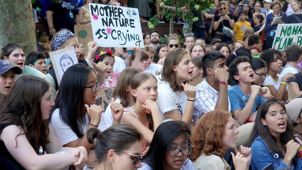 Group of young people and Greta protesting outside of the UN Headquarter gates