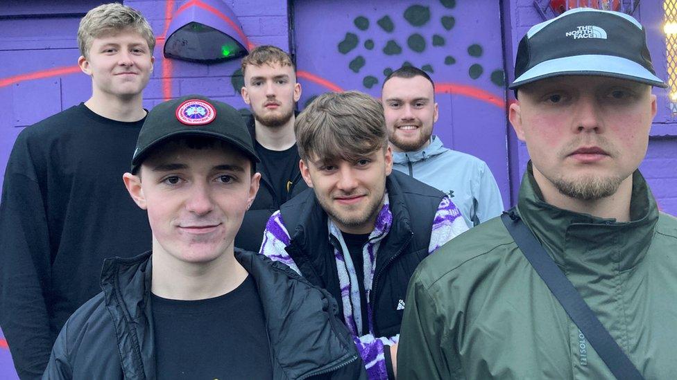 Adam Woods' friends standing in front of the mural in Orangefield Park