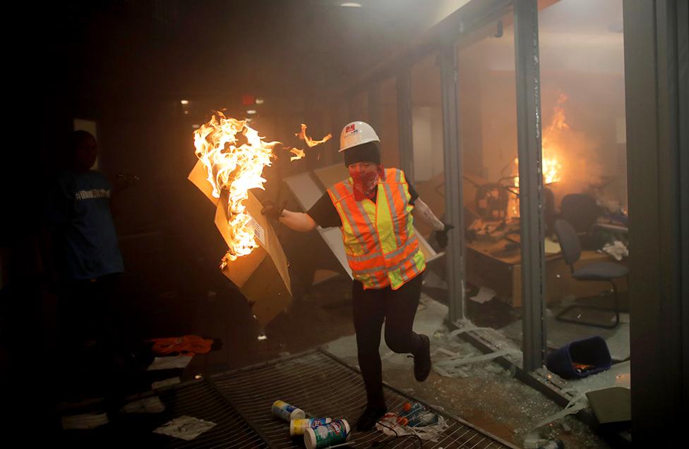 Protesters are seen inside Minneapolis Police 3rd precinct