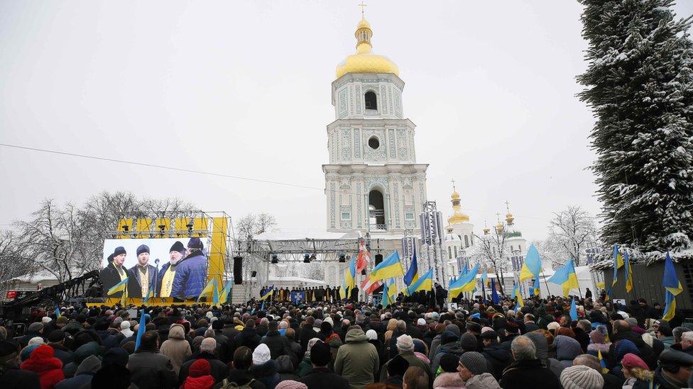 Ukrainians gather outside Saint Sophia's Cathedral bell tower in Kiev