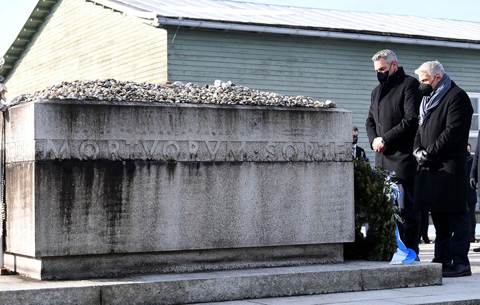 Austrian Chancellor Karl Nehammer and Israel's Foreign Minister Yair Lapid attend a commemoration ceremony at the Mauthausen Memorial, the site of a Nazi concentration camp in Mauthausen, Austria, on 27 January 2022