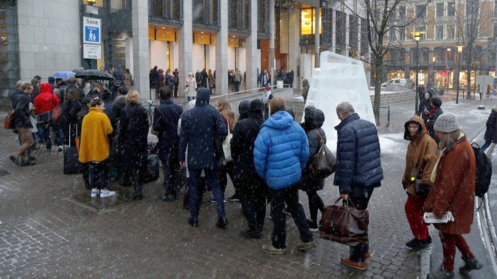 People queue to enter the courthouse in Oslo, Norway