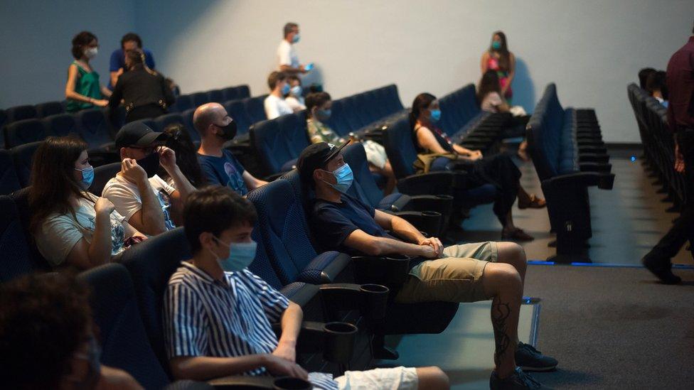 Customers wear face masks in a cinema