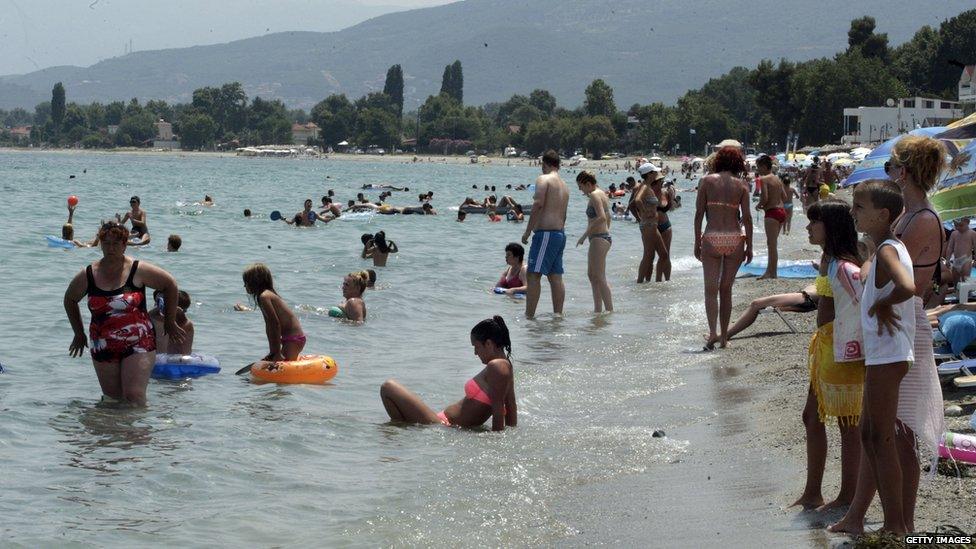 Tourists on beach at Paralia, Greece - 9 Jul 15