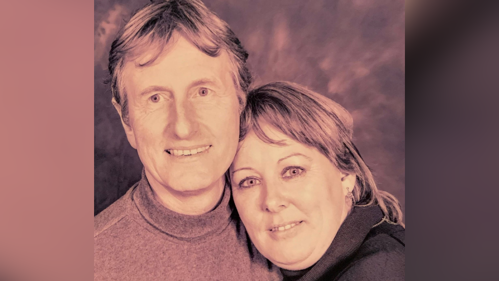 Melvin and Dorothy Cook. It is an old photograph of the couple. Dorothy has her head on Melvin's shoulder. Both of them are looking at the camera and smiling. 