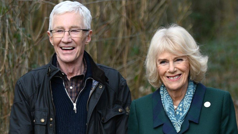 Camilla, Duchess of Cornwall, patron of Battersea Dogs and Cats Home and Battersea Ambassador Paul O'Grady on a brief woodland walk with a rescue dog which is yet to be re-homed, during her visit to Battersea Brand Hatch Centre on February 2, 2022 in Ash, England.