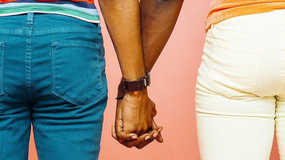 Two people holding hands