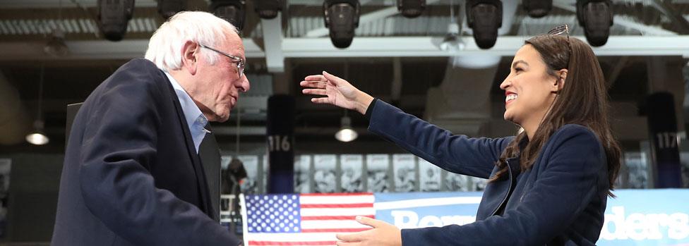 Sanders is greeted by Congresswoman Alexandria Ocasio-Cortez