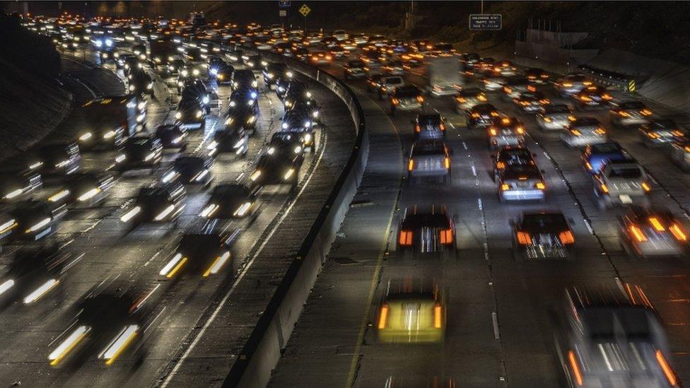 This February 13, 2013 file photo shows cars and trucks as they move through traffic in Los Angeles, California.