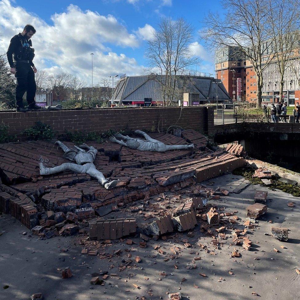 Cartwheeling statues rubble