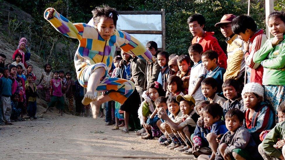 A girl competes in the long jump