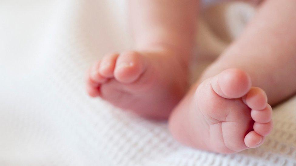 Feet of baby on a white blanket