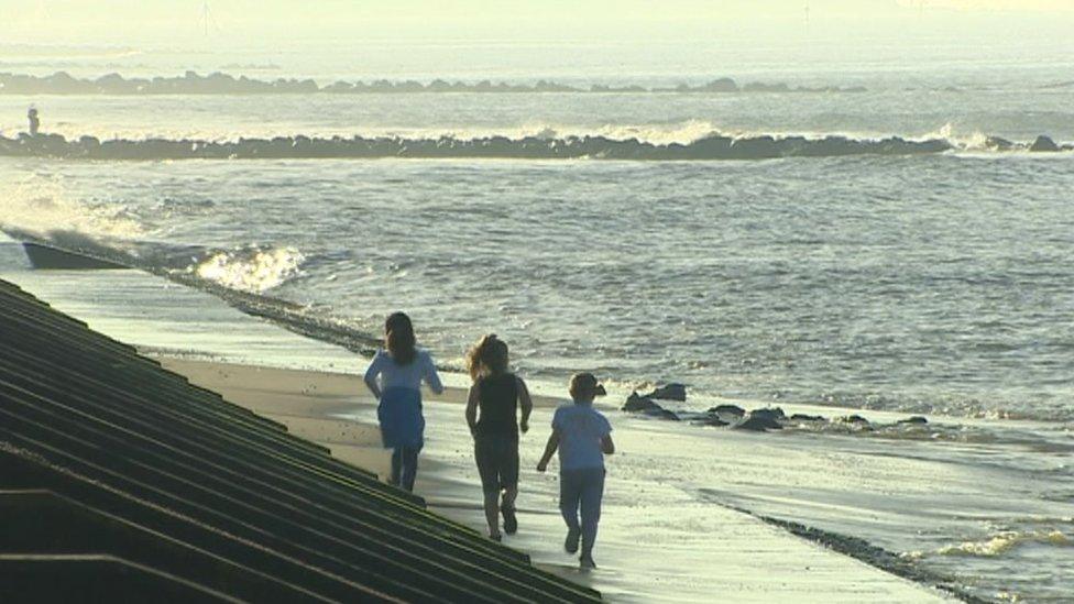 Children playing at Prestatyn beach in the sun