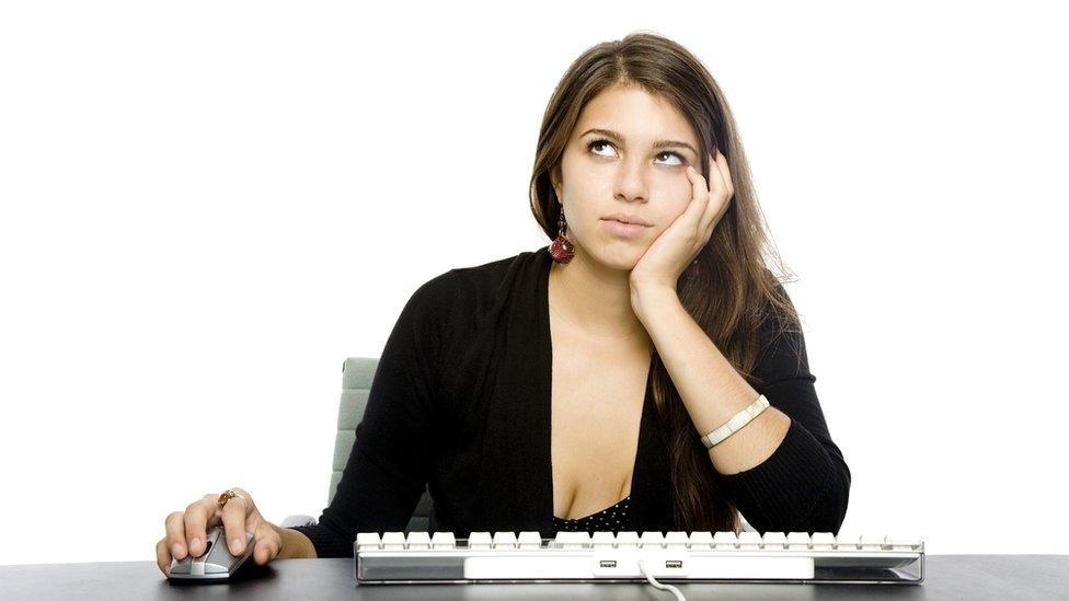 Woman rolling eyes at keyboard