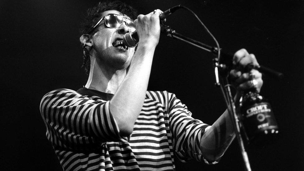 Shane MacGowan performing with the Pogues