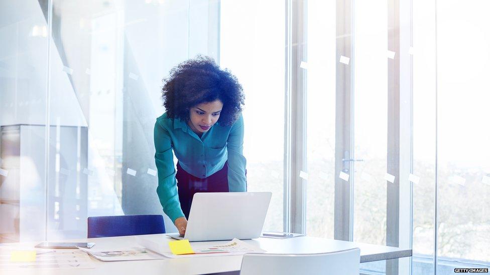 Woman working at laptop on desk