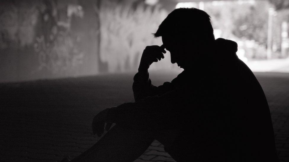 A man's shadow in an underpass