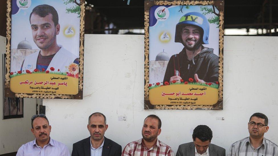 Posters showing Ahmed Abu Hussein (Top R) and Yaser Murtaja (Top L) at an exhibition organised by Palestinian journalists in Gaza City (2 May 2018)