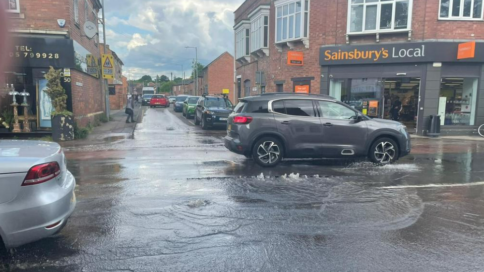 Cars driving through a puddle