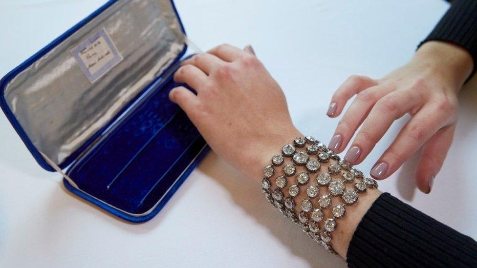 A staff wears a pair of diamond bracelets fitted together, with approximately 140 to 150 carats and owned by Queen Marie-Antoinette of France