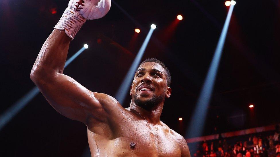 Anthony Joshua celebrates winning a recent fight