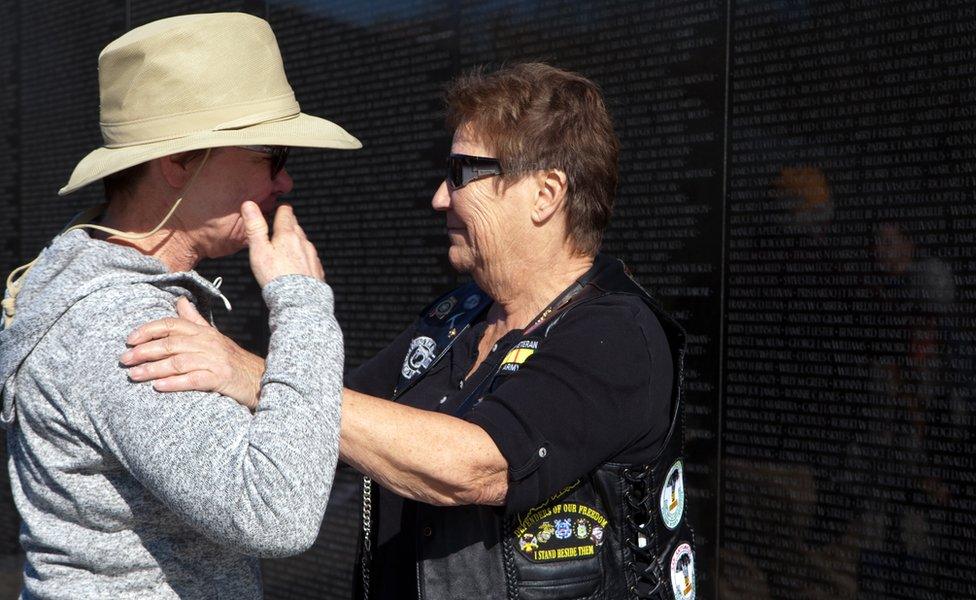 A visitor to the Vietnam Veterans Memorial known on the National Mall in Washington DC is comforted by Vietnam Veteran Staff Sgt Claire Brisebois Starnes