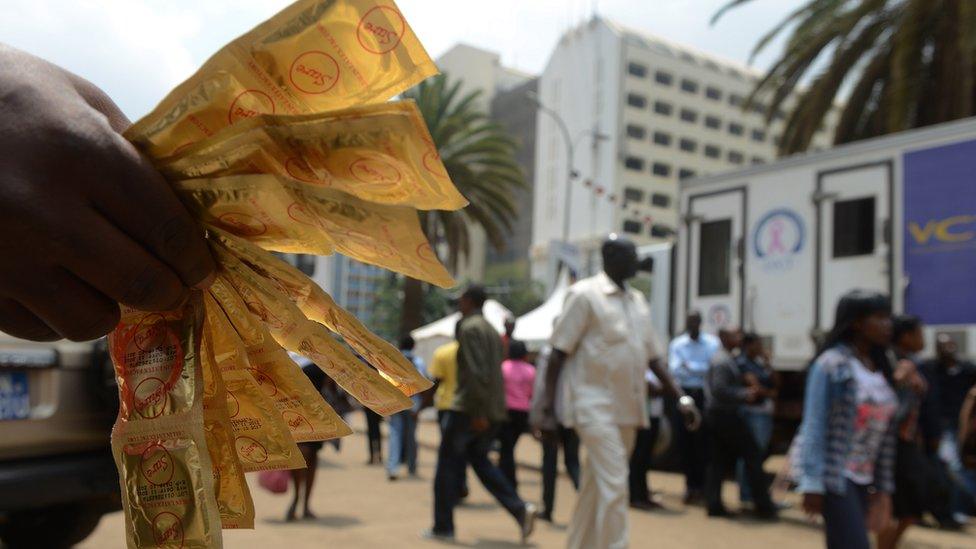 An Aids Healthcare Foundation-Kenya worker distributes condoms in the streets of Nairobi on February 14, 2014