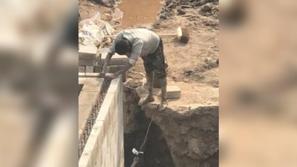 Builder working barefoot