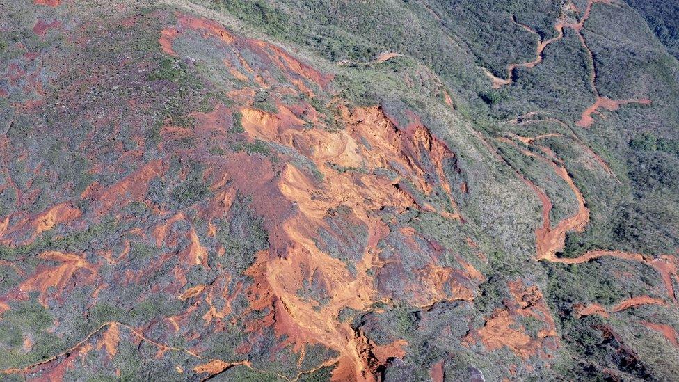 A hillside with open mines