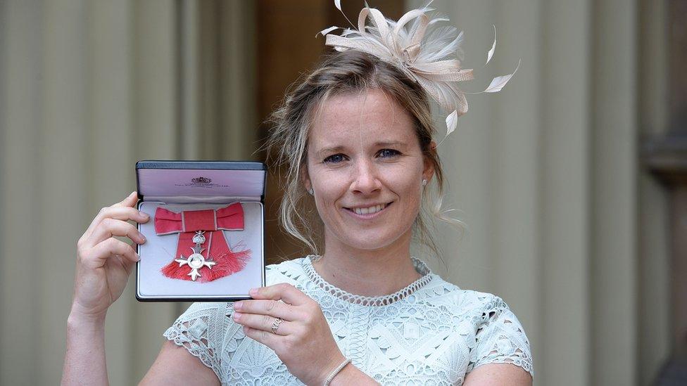 Sailor Hannah Mills holding her MBE