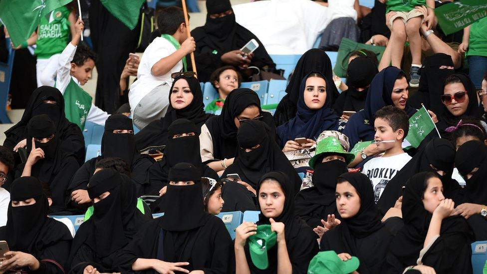 Saudi women sit in a stadium for the first time to attend an event