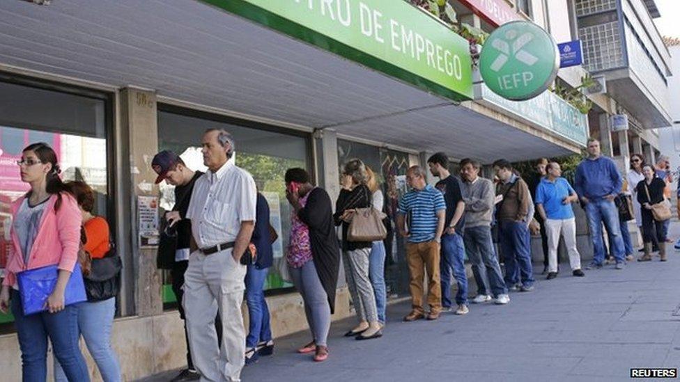 People wait at the employment centre to open in Sintra, Portugal