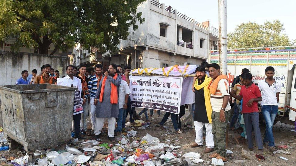 Activists stage a mock funeral to protest the BJPs development-focused campaign in Gujarat 2017