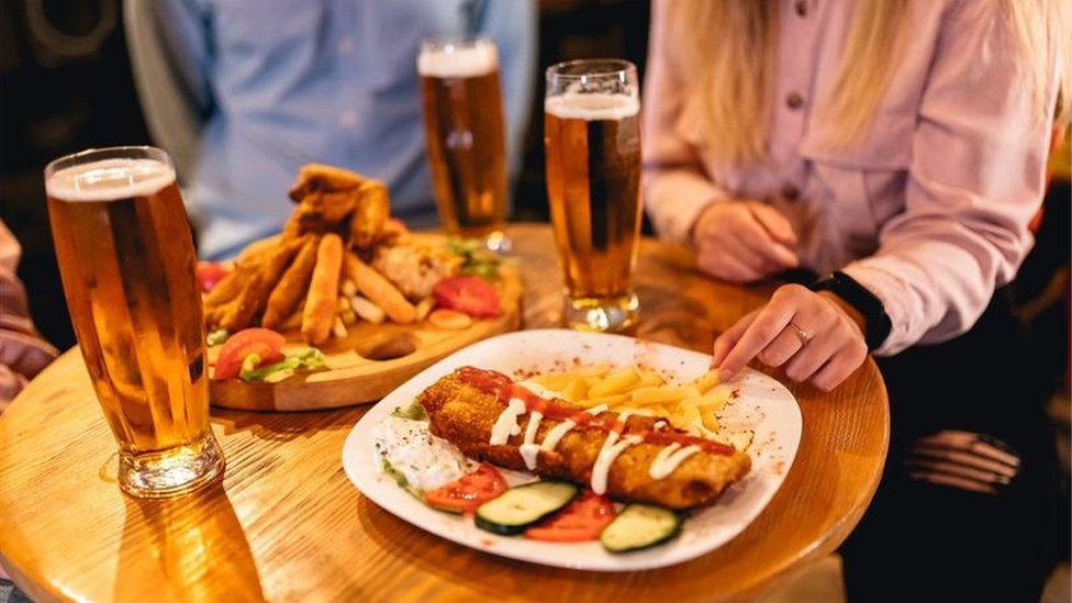 Stock image of people eating and drinking