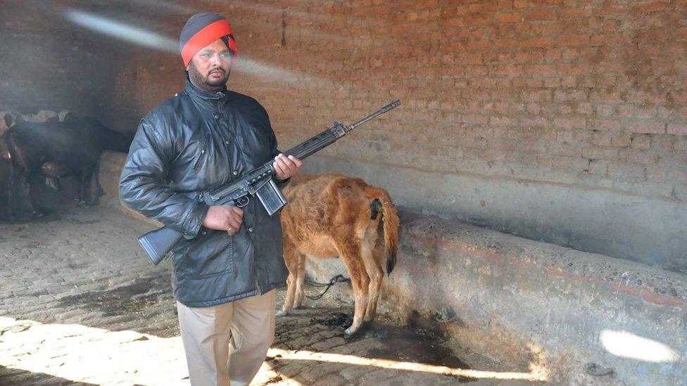 A Punjabi policeman inspects an area near an air force base following an attack