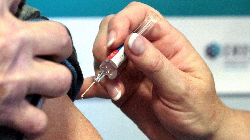 Someone being given a Covid vaccine as part of a trial