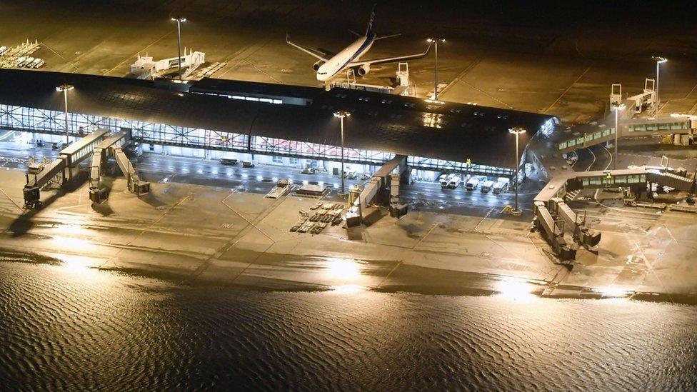 An aerial view shows a flooded runway at Kansai airport, Osaka on 4 September 2018